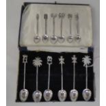 Twelve Indian silver coloured metal spoons, each terminal with an ornamental finial