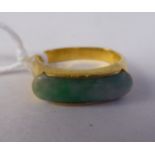 A Chinese high grade gold ring, set with a jade tablet