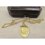 A Chinese 22ct gold curb link chain and a heart shaped pendant, embossed with flowers