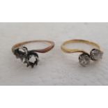 An 18ct gold two stone, claw set diamond crossover ring; and another similar, but with one loose