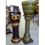 Two West German pottery jardinière pots and stands with floral decoration  25" & 32"h