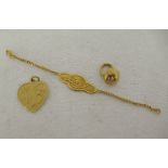 Three Chinese 22ct gold items of personal ornament: to include a heart shaped pendant