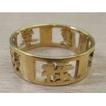 A Chinese 14ct gold ring pierced with Chinese characters