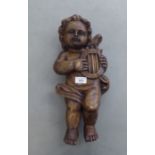 A vintage carved wooden papier mache mould, fashioned as a standing cherub with a lyre  18"h