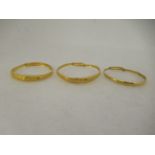 Three Chinese 22ct gold adjustable bangles