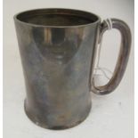 A silver Christening tankard of cylindrical form, on a splayed base with a hollow loop handle