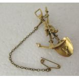 A yellow metal gold prospector's brooch, fashioned as a shovel and pickaxe