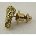 A gold nugget pin brooch