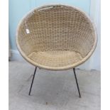 A 1960s woven and split cane Sputnik design chair, raised on a black painted, steel wire underframe