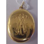 A (probably 18ct gold) oval double hinged and engraved locket