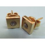 A pair of 14ct gold stud earrings, each set with a diamond