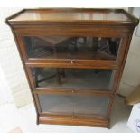 An early 20thC oak Globe Wernicke style three section glazed bookcase, on a plinth  48"h  34"w