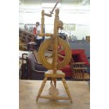 A mid 20thC turned beech spinning wheel