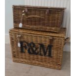 Two similar Fortnum & Mason woven cane hampers with buckled straps  10"h  20"w and 15"h  22"w