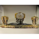 An Art Deco marble and onyx three piece clock garniture, the angular case surmounted by a silvered