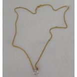 A claw set cubic zirconia pendant, on a fine twist link, gold coloured metal chain  stamped 750,