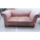 A late Victorian fabric upholstered drop-end Chesterfield, raised on turned feet  66"w