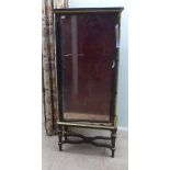 A late 19thC French Empire style display cabinet, partially glazed with black and gilt trim,