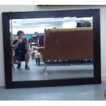 A modern mirror, the bevelled plate in a painted frame  36" x 46"