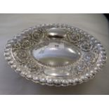 A Victorian silver oval dish with cast and chased scrolled decoration  London 1887  9"w