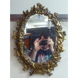 A late 19thC mirror, in a cast iron gilt painted foliate design frame  19" x 14"
