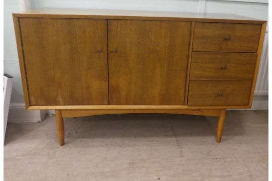 A Vanson teak sideboard with a pair of cupboard doors, adjacent to three drawers, raised on turned - Image 1 of 4