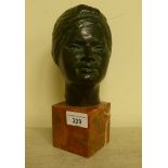A cast and patinated green bronze bust, a young woman  stamped P Gambino, on a mottled marble plinth