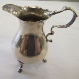 A George II silver bulbous cream jug with a double C-scrolled handle, on pad feet  London 1759