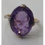 A gold coloured metal, possibly 9ct, ring, set with an amethyst