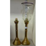 A pair of late Victorian brass candlesticks  13"h one with a glass shade