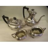 An Edwardian four piece silver tea set of demi-reeded, oval form, the teapot with a swept spout,