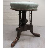 An Edwardian carved mahogany framed and later fabric covered rotating top stool, on a tripod base