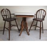 Small furniture: to include a pair of 20thC child's stained beech highchairs, raised on turned legs