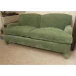 An LM Kingcome Ltd Salisbury two person settee, upholstered in green fabric on block feet  87"w
