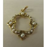 A Victorian yellow metal and seed pearl set, open quatrefoil pendant