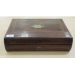 A late Regency brass string inlaid rosewood writing box of cushion moulded form, the lockable,