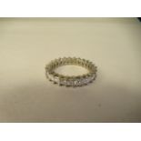 A 14ct white gold and diamond full eternity ring, claw set with twenty six princess cut stones (