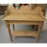 An early 20thC rustic pine washstand, raised on turned legs, united by a platform undershelf  38"