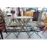 A shabby chic washed green painted iron terrace set  comprising a folding table  30"h  28"dia; and a
