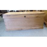 An early 20thC bordered waxed pine chest with straight sides and a hinged lid  19"h  43"w