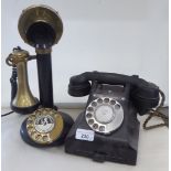 A vintage black Bakelite dial telephone; and a reproduction of a stick telephone