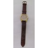 A gold plated stainless steel cased wristwatch, faced by a crocodile skin effect, brown hide strap