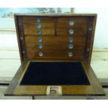 An early 20thC oak and mahogany travellers tool chest, comprising an arrangement of ten short,