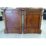 A pair of modern yewwood bedside cupboards, each with a single drawer, over an enclosed shelf,