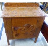 A modern Irish inspired carved teak side cabinet with a panelled door, raised on square legs  39"