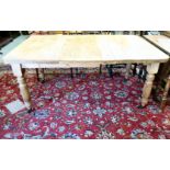 A late 19thC rustic pine kitchen table, raised on ring turned legs  29.5"h  61"w