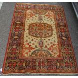 A Persian Bachtia design rug, on a burnt orange and multi-coloured ground  54" x 74"