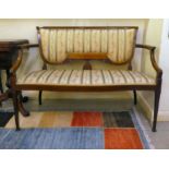 An Edwardian string inlaid mahogany two person salon settee with striped and floral patterned