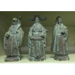 Three similar Chinese patinated bronze standing figures  9"h
