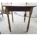 An early 20thC pine and oak table, raised on turned legs  29"h  35"dia